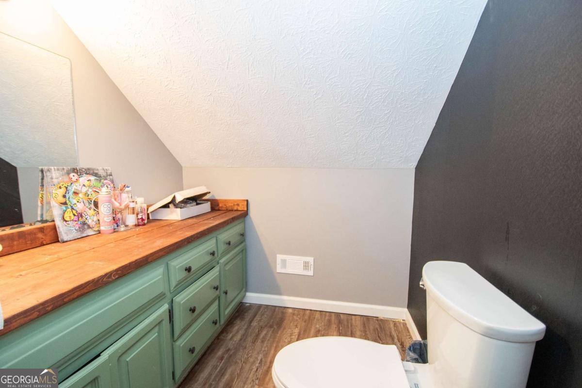 3414 Rock Mills Road LaGrange, GA 30240 - Photo 32 of 54 a bathroom with a toilet a sink and mirror