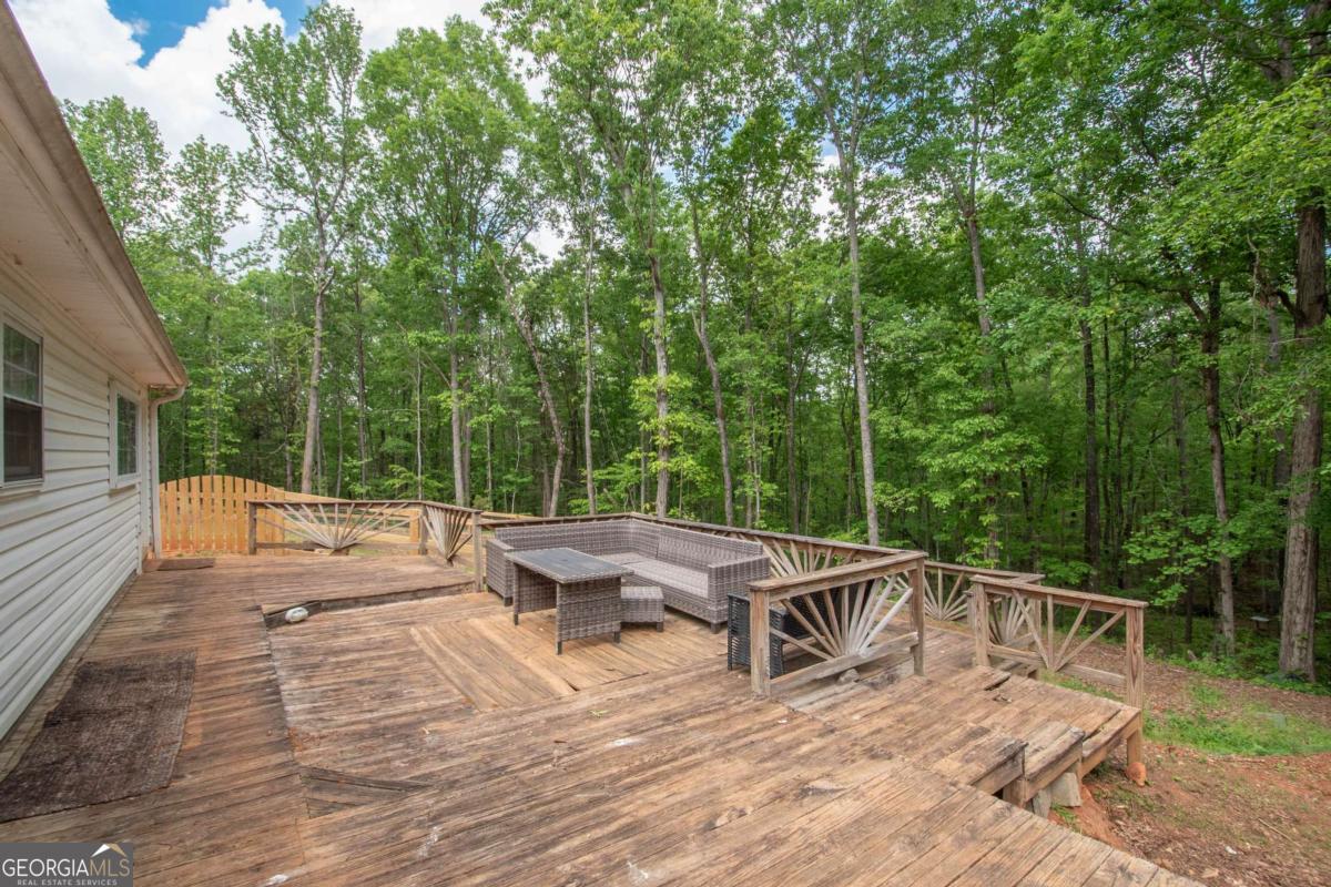 3414 Rock Mills Road LaGrange, GA 30240 - Photo 33 of 54 a view of a patio with table and chairs with wooden floor and fence