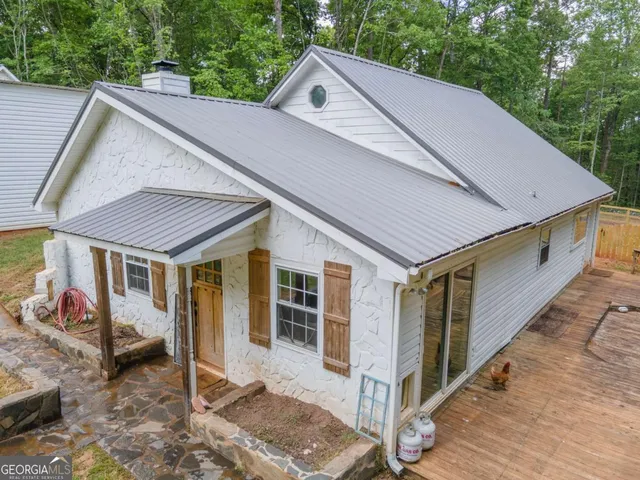 a aerial view of a house with a yard and balcony