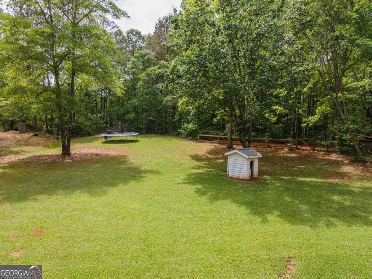 3414 Rock Mills Road LaGrange, GA 30240 - Photo 44 of 54 a view of a swimming pool with an outdoor space and seating area