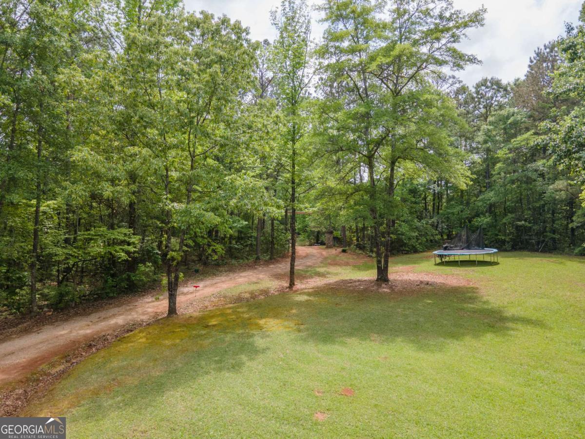 3414 Rock Mills Road LaGrange, GA 30240 - Photo 45 of 54 a swimming pool with trees in the background