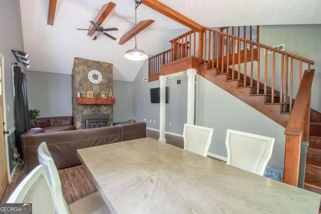 a view of a livingroom with furniture staircase and a fireplace