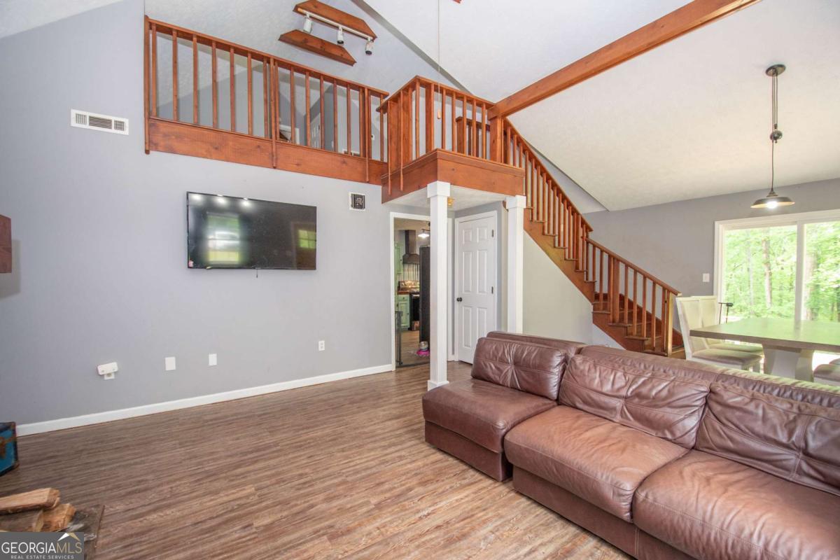 3414 Rock Mills Road LaGrange, GA 30240 - Photo 9 of 54 a living room with furniture ceiling fan and a wooden floor