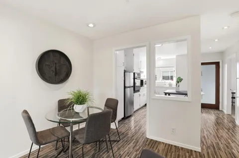 a dining room with furniture and wooden floor
