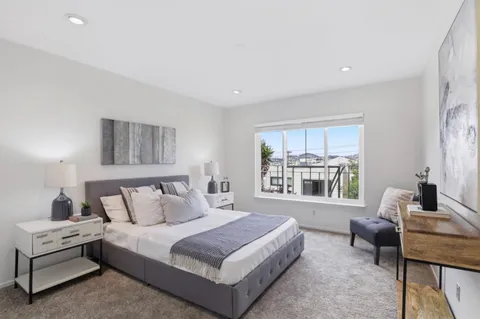 a spacious bedroom with a bed and a couch