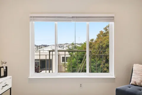 a view of a room that has a bed and a window
