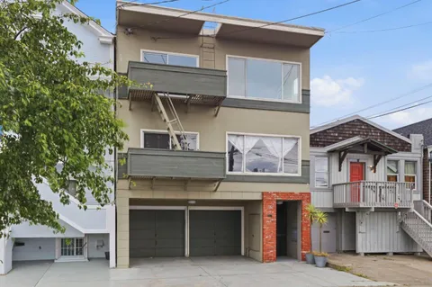 a view of a house with a balcony and door