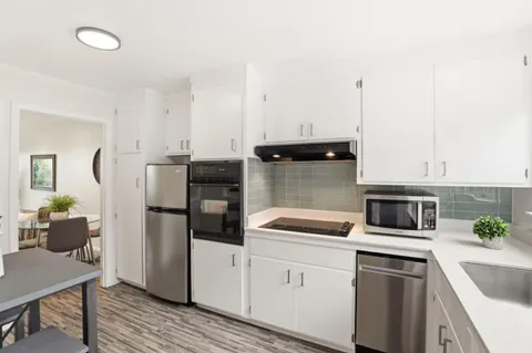 a kitchen with cabinets and stainless steel appliances