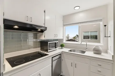 a kitchen with a sink and cabinets