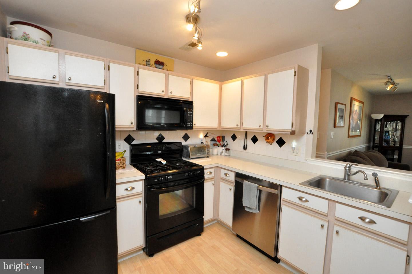 1505 Squirrel Road Evesham, NJ 08053 - Photo 9 of 23 a kitchen with granite countertop a refrigerator stove and sink