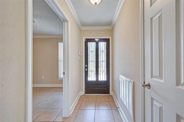 a view of a hallway with a glass door and a window