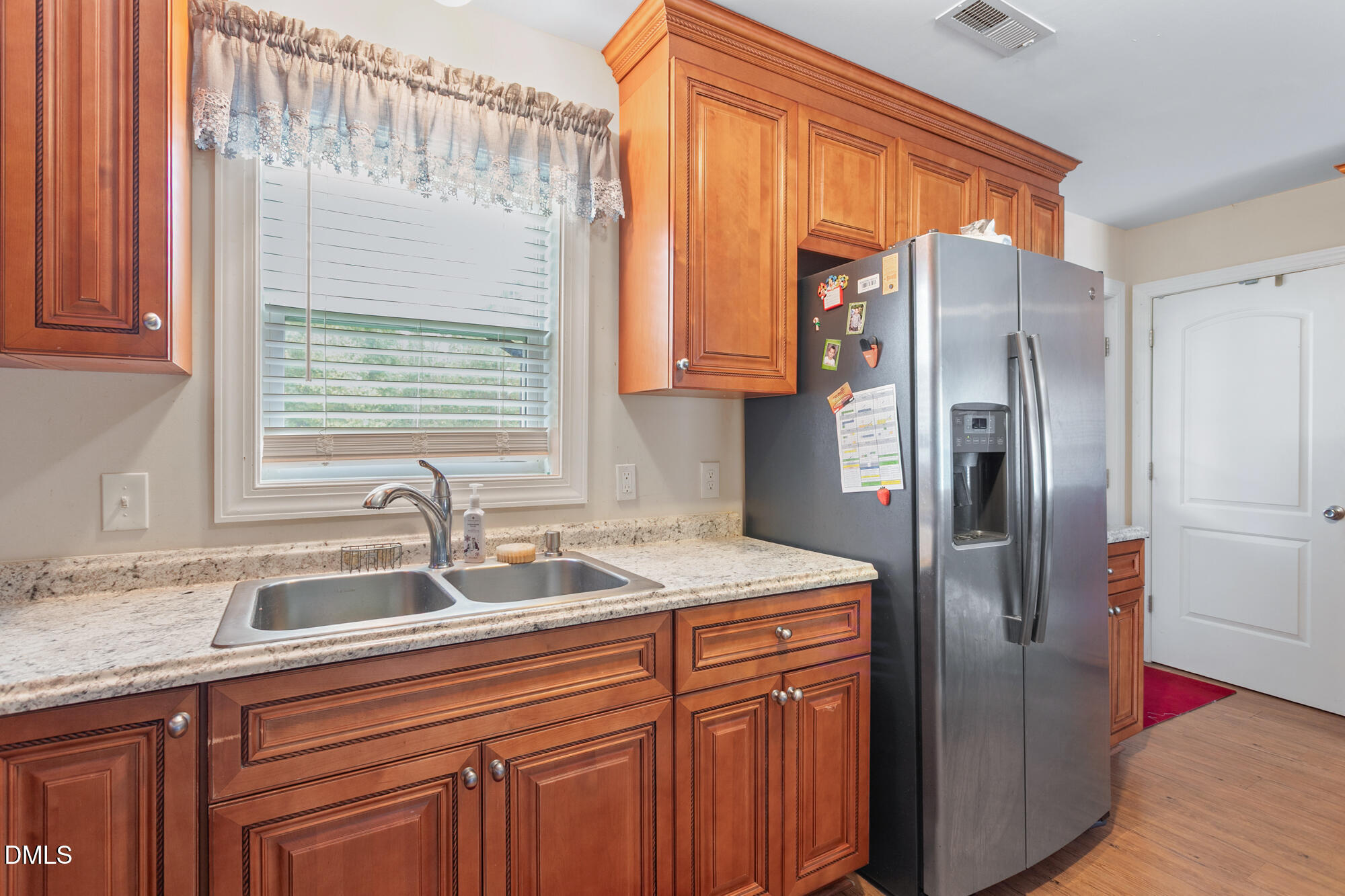 3163 Saul Loop Road Elon, NC 27244 - Photo 27 of 44 a kitchen with stainless steel appliances granite countertop a refrigerator and a sink