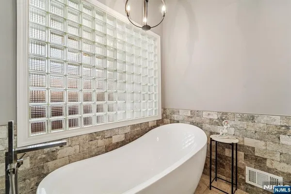 a bathroom with a bathtub and shower