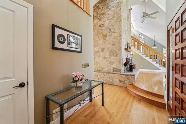 a view of a hallway with a dining table and chairs