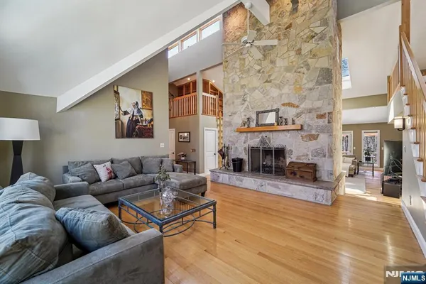 a living room with fireplace furniture and a wooden floor