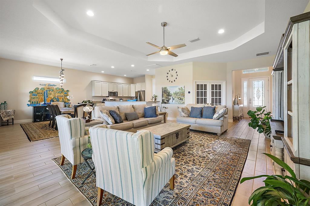 5129 Jared's Landing Way Oxford, FL 34484 - Photo 12 of 41 a living room with furniture kitchen view and a chandelier