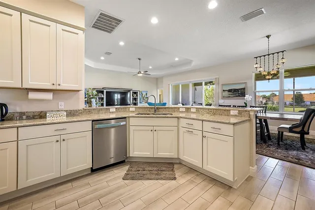a kitchen with sink cabinets and outdoor view