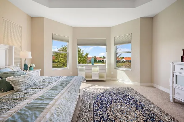 a large bedroom with a bed and glass door