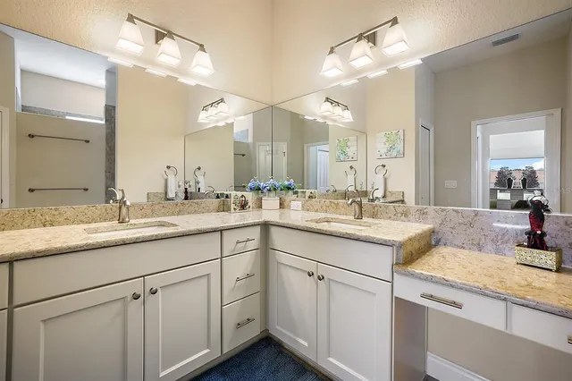 a bathroom with a sink vanity granite and a mirror