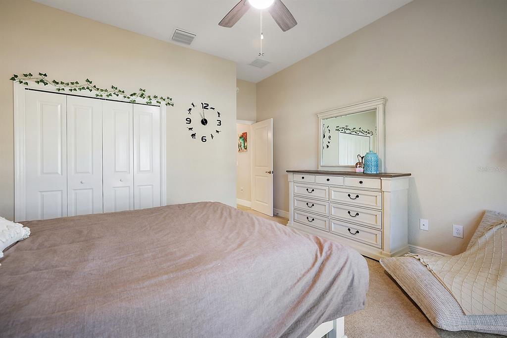 5129 Jared's Landing Way Oxford, FL 34484 - Photo 25 of 41 a bedroom with a bed and a dresser