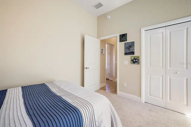 a bedroom with a bed and cabinets