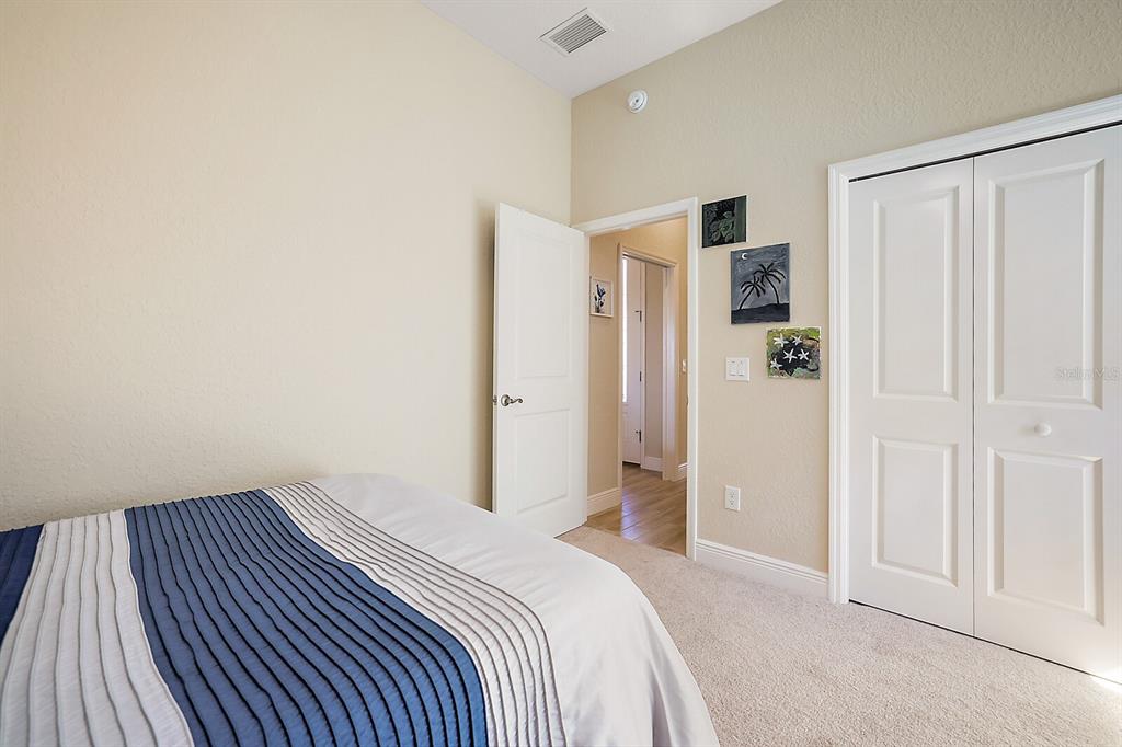 5129 Jared's Landing Way Oxford, FL 34484 - Photo 27 of 41 a bedroom with a bed and cabinets