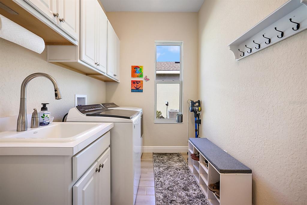 5129 Jared's Landing Way Oxford, FL 34484 - Photo 29 of 41 a utility room with sink dryer and washer