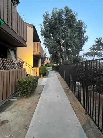 a view of a pathway front of house with wooden fence