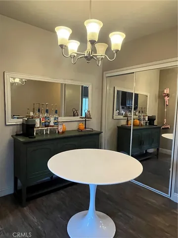 a kitchen with a table chairs and a chandelier