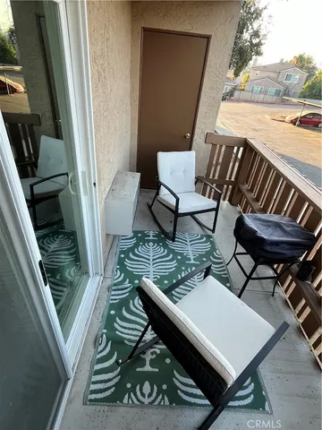 a living room with chairs and a table