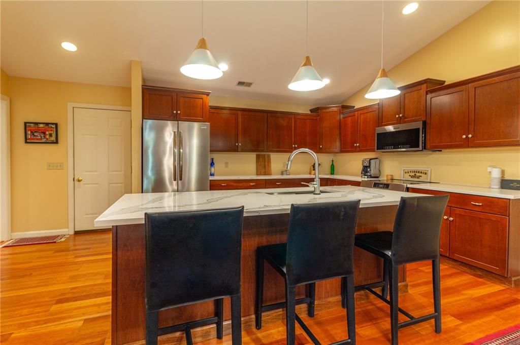 138 Abbey Road New Castle, PA 16105 - Photo 15 of 36 a kitchen with stainless steel appliances granite countertop table chairs sink and cabinets