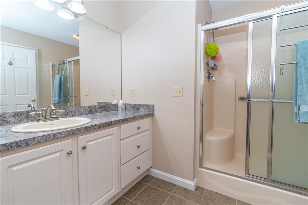 138 Abbey Road New Castle, PA 16105 - Photo 27 of 36 a bathroom with a granite countertop shower sink and mirror