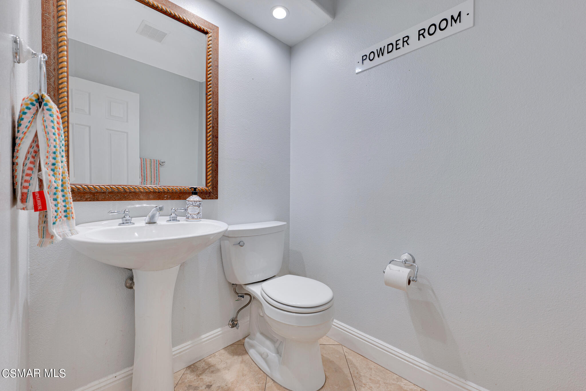 3930 Sunsetridge Road Moorpark, CA 93021 - Photo 11 of 42 a bathroom with a sink a toilet and mirror