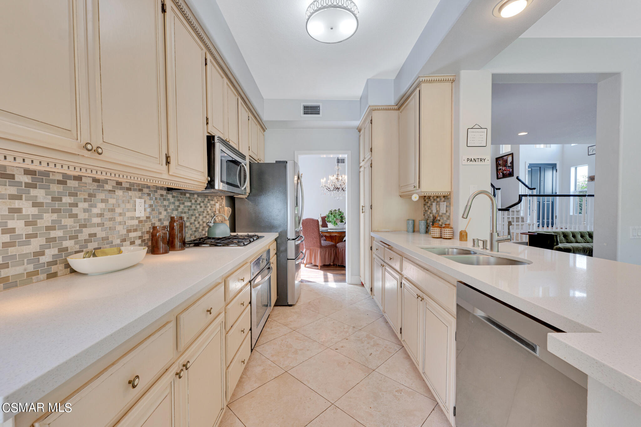 3930 Sunsetridge Road Moorpark, CA 93021 - Photo 14 of 42 a kitchen with kitchen island granite countertop a sink white cabinets and stainless steel appliances
