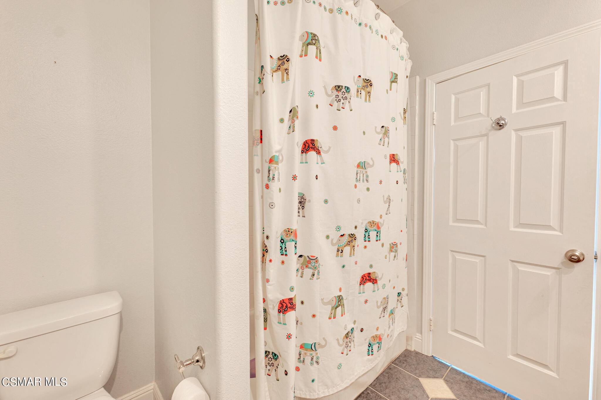 3930 Sunsetridge Road Moorpark, CA 93021 - Photo 24 of 42 a bathroom with a shower curtain and a toilet