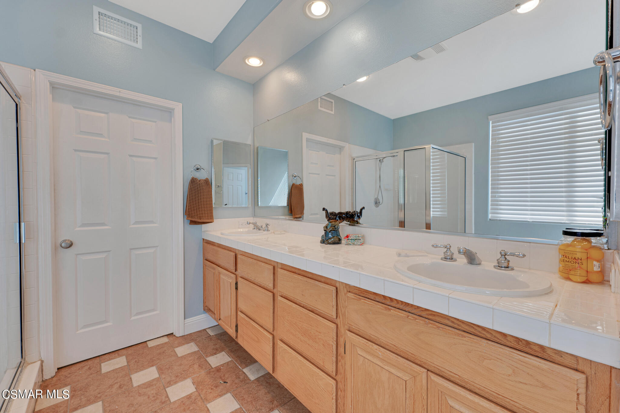 3930 Sunsetridge Road Moorpark, CA 93021 - Photo 27 of 42 a spacious bathroom with a sink a mirror and a shower