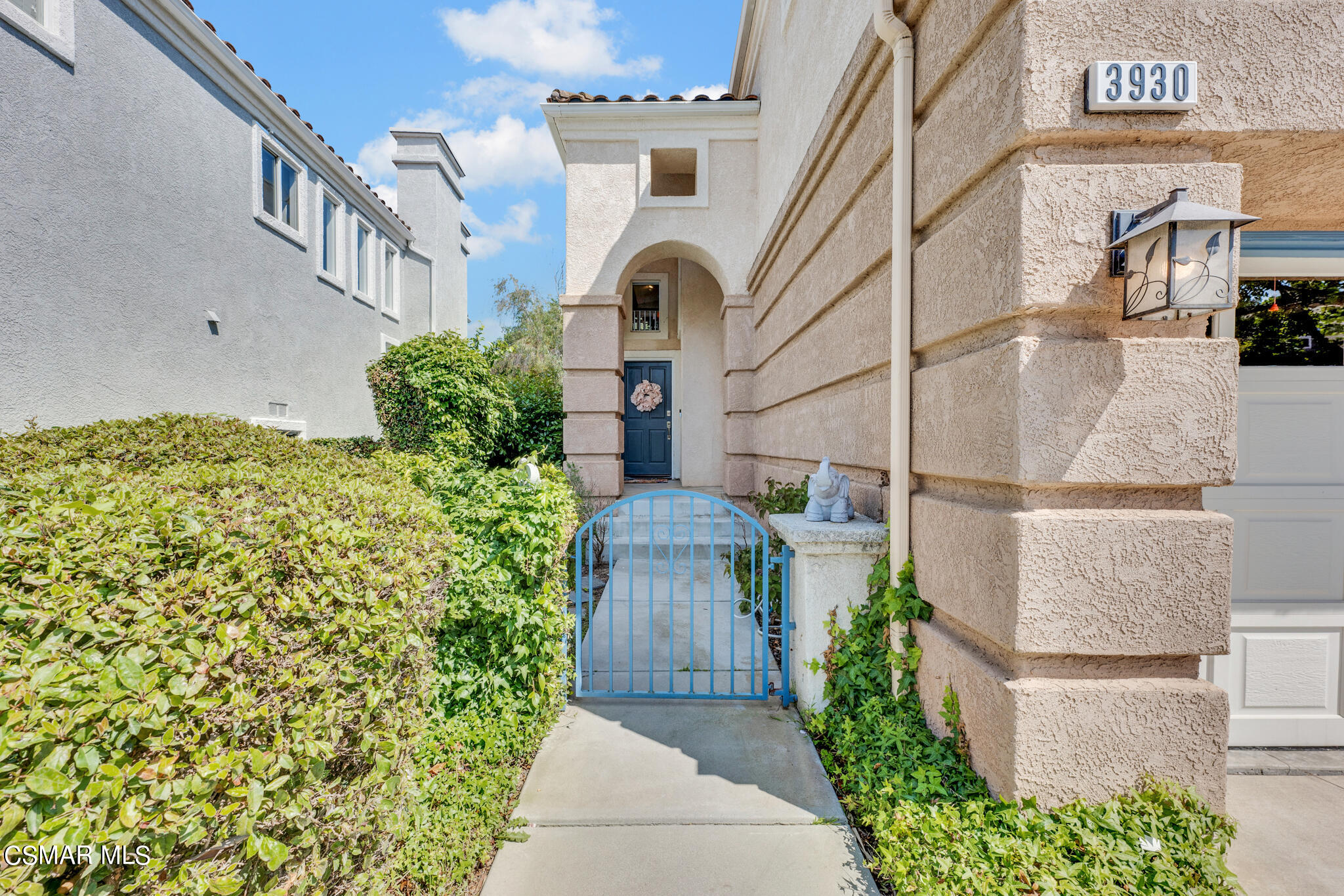 3930 Sunsetridge Road Moorpark, CA 93021 - Photo 4 of 42 a view of a brick house with a large windows and flower plants