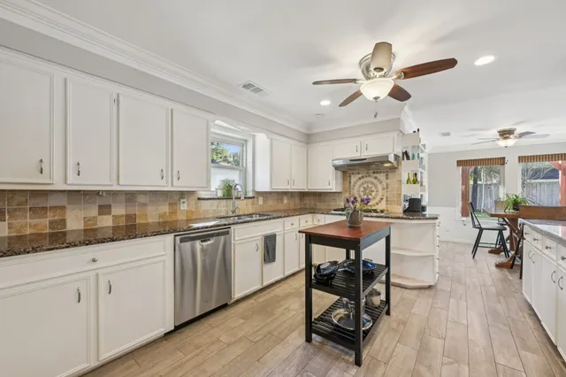 a bedroom with a bed and a dresser with mirror
