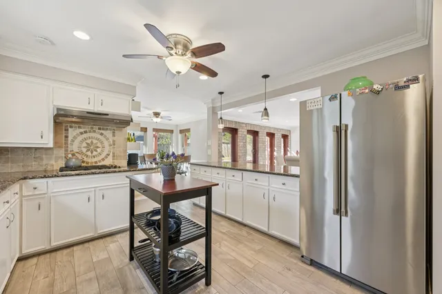 a spacious bathroom with a tub sink and mirror