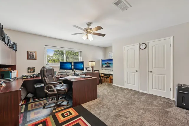 a front view of a house with a garden and yard