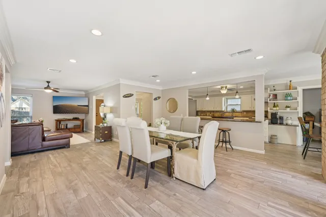 a view of a dining room with furniture and wooden floor