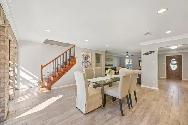 a view of a dining room with furniture window and wooden floor