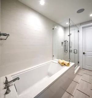 a spacious bathroom with a bathtub and a shower