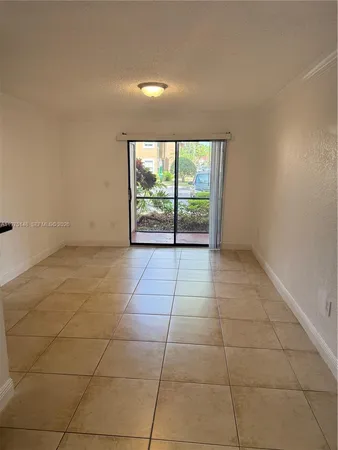 a view of an empty room with a floor to ceiling window