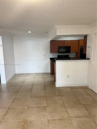 a living room with a microwave and a stove top oven