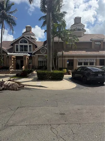 a couple of cars parked in front of building