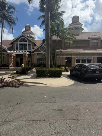 a couple of cars parked in front of building