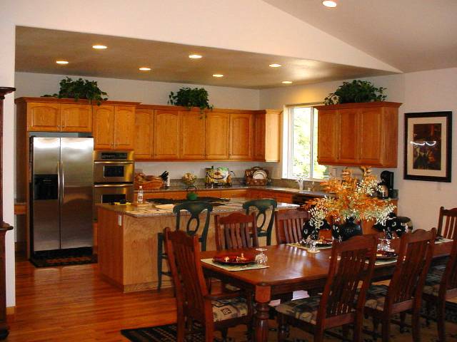 1005 Nottingham Way Tahoe Vista, CA 96148 - Photo 4 of 7 a kitchen with a dining table chairs and refrigerator