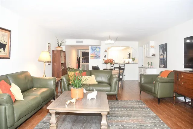 a living room with furniture and a dining table