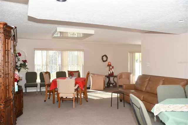 a view of a livingroom with furniture and a large window